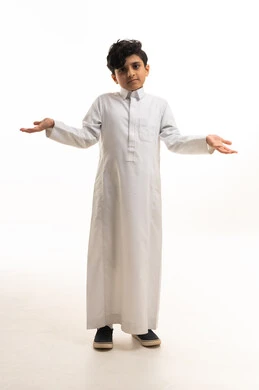 Saudi Boy in Traditional Thobe Shrugging in Studio