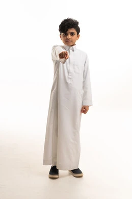 Saudi Boy in White Thobe Pointing at Camera