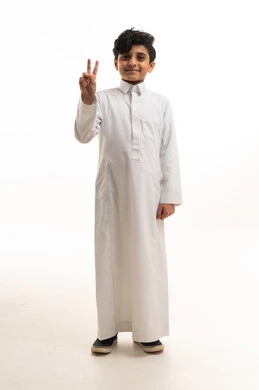 Saudi Boy in White Thobe Making Peace Sign