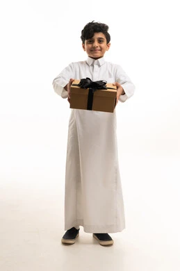 Saudi Boy in White Thobe Holding a Gift Box