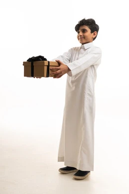 Saudi Boy in White Thobe Holding a Gift Box Studio Shot