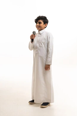 Saudi Boy in Traditional Thobe Holding Microphone