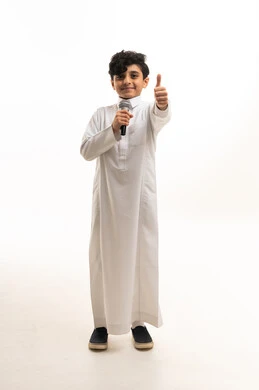 Saudi Boy in White Thobe Holding Microphone and Thumbs Up