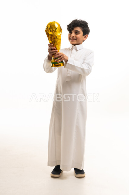 Saudi Boy in White Thobe Holding Golden Trophy