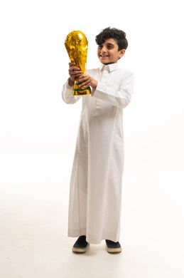 Saudi Boy in White Thobe Holding Golden Trophy