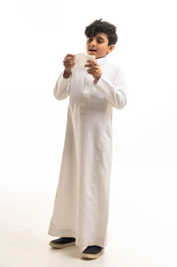 Saudi Boy in White Thobe Holding Tissue