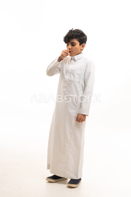 Saudi Boy in Traditional White Thobe Coughing