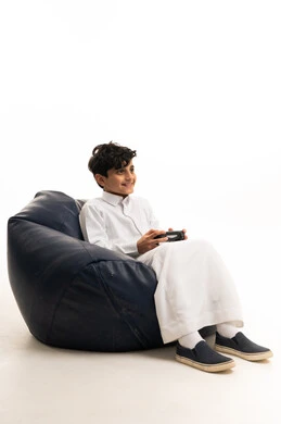 Saudi Boy Playing Video Games in White Thobe
