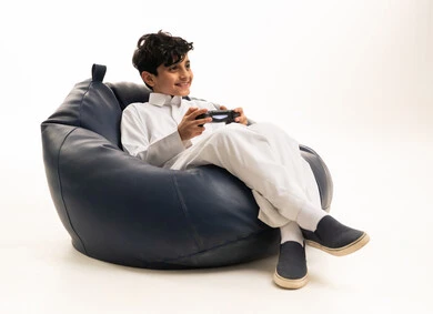 Saudi Boy Gaming on Bean Bag White Background