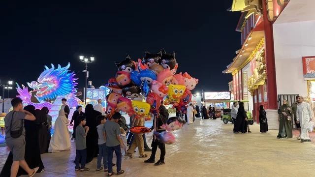 Balloon Vendor and Crowds at Global Village Dubai Night