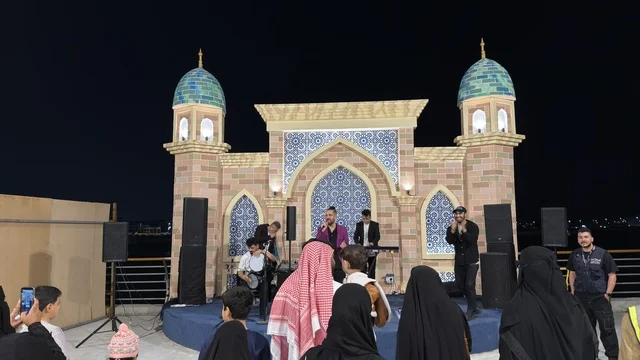 Live Band Performance on Traditional Arabic Stage at Night
