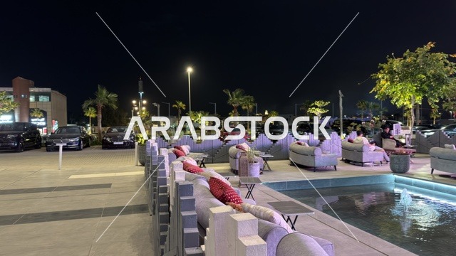 جلسة خارجية حديثة مع نافورة مياه وإضاءة ليلية