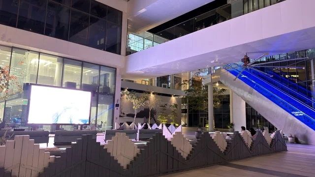 Modern Shopping Mall Interior with Digital Screen at Night
