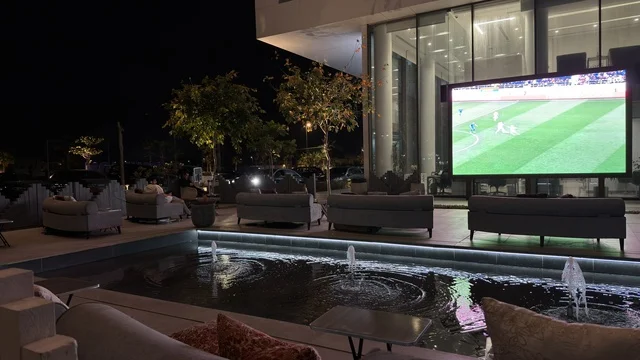 Outdoor Lounge Football Screen and Water Fountain Night