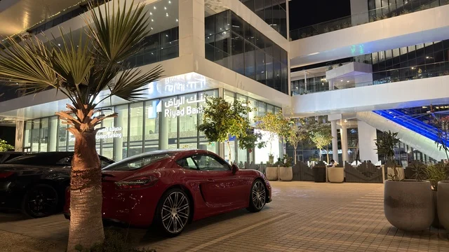 سيارة رياضية أمام مبنى بنك الرياض في الليل