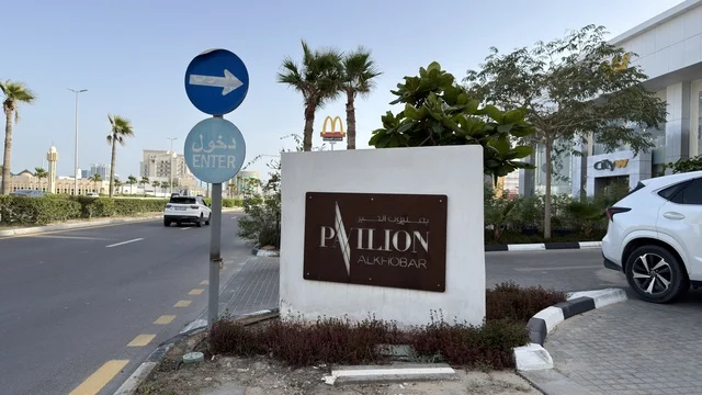 لوحة مدخل بافيليون الخبر ومشهد جانب الطريق