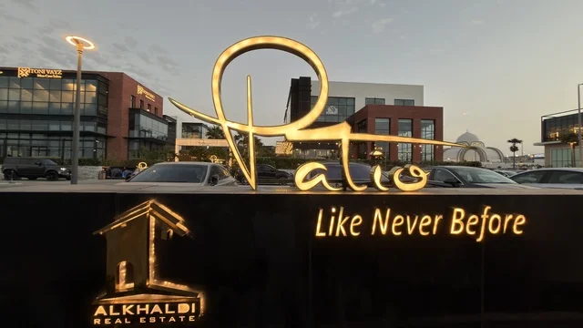 Patio Alkhaldi Real Estate Illuminated Sign at Dusk
