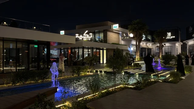 Modern Commercial Plaza with Water Fountain at Night