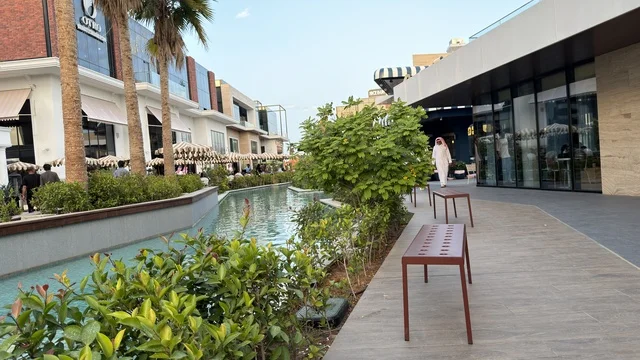 Modern Outdoor Shopping Mall with Water Canal and Palms
