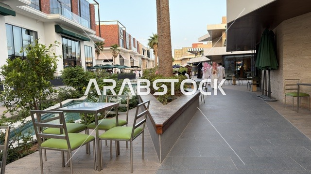Modern Outdoor Mall Plaza with Cafe Seating and Palms