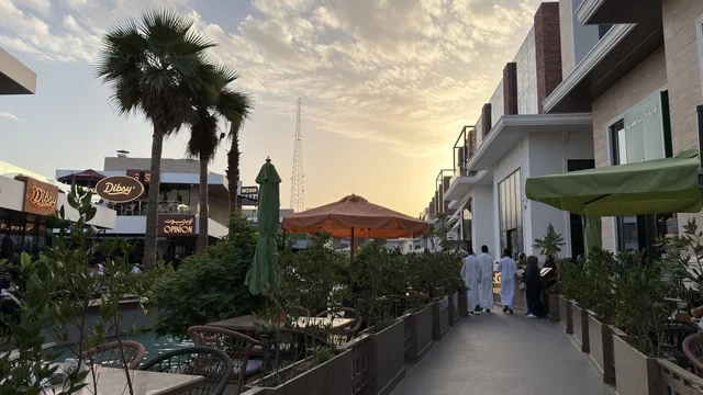 مجمع تسوق خارجي حديث وقت الغروب مع مشاة