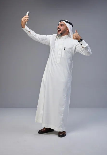 Saudi Man in Traditional Dress Taking Selfie