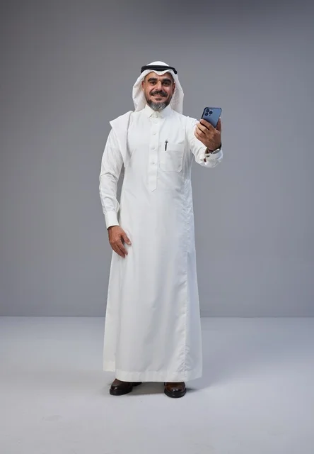 Saudi Man in Traditional Dress Taking Studio Selfie