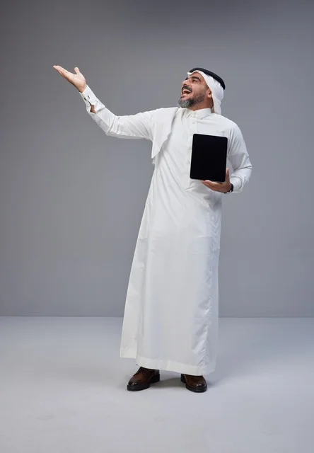 Saudi Man Holding Tablet Gesturing in Studio Portrait