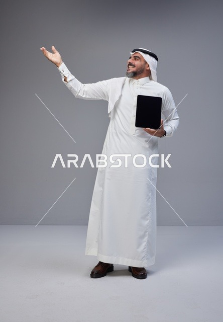 Saudi Man Holding Blank Tablet Screen in Studio