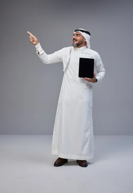 Saudi Man Holding Tablet with Blank Screen Pointing