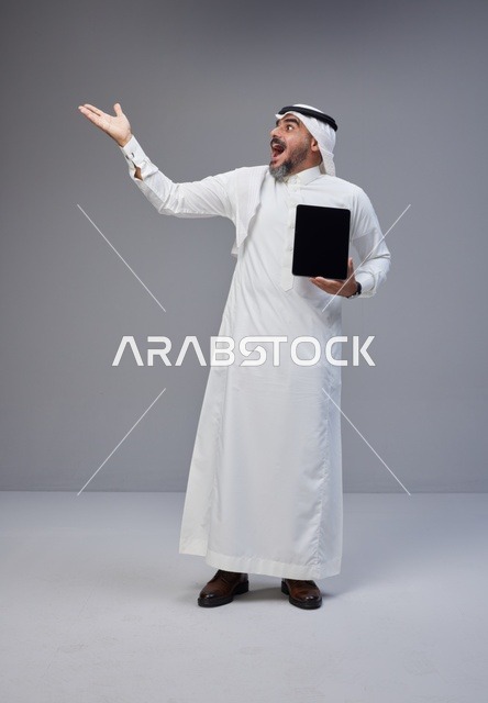 Saudi Man Holding Tablet Blank Screen Gesturing Up
