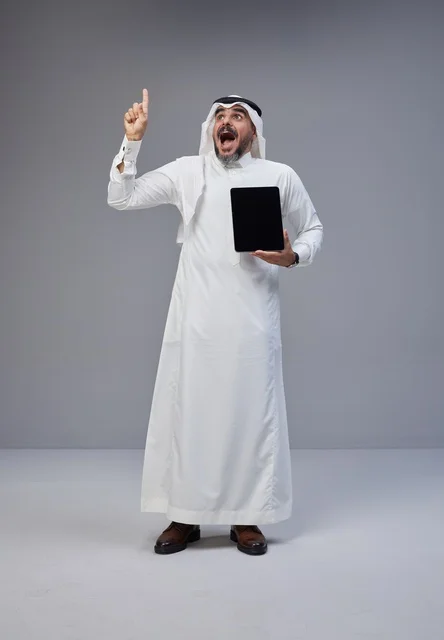 Saudi Man with Tablet Pointing Up Excited Studio Shot