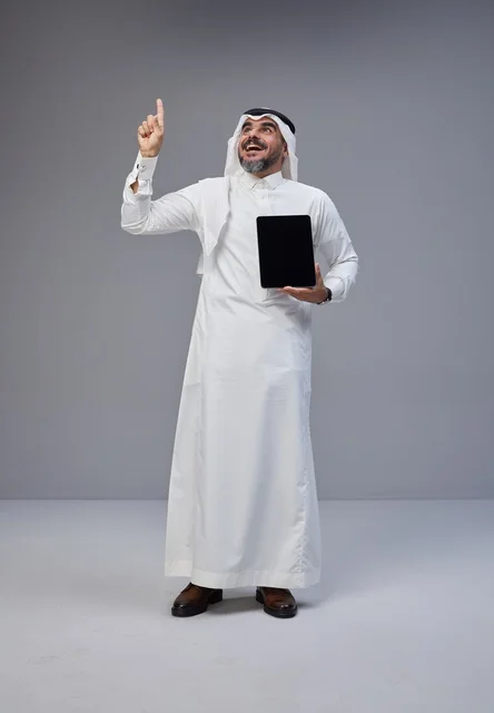 Saudi Man Holding Blank Tablet Pointing Upward