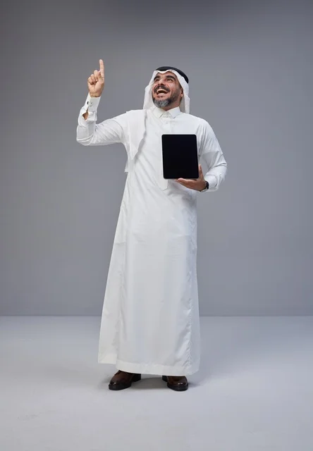 Saudi Man in Traditional Thobe Holding Tablet Pointing Up