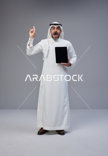 Saudi Man Holding Tablet Blank Screen Excited