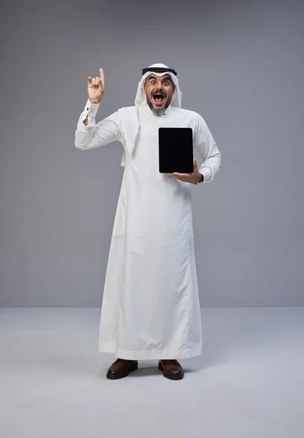Saudi Man Holding Blank Tablet Pointing Upwards