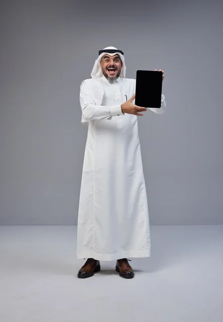 Saudi Man in Traditional Dress Holding Blank Tablet
