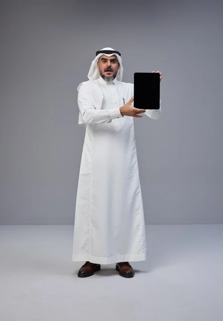 Saudi Man Holding Blank Tablet with Surprised Expression