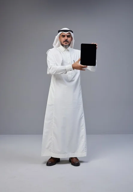 Saudi Man in Traditional Thobe Holding Blank Tablet