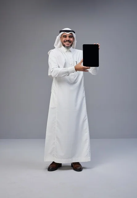 Saudi Man in Traditional Dress Holding Blank Tablet Screen