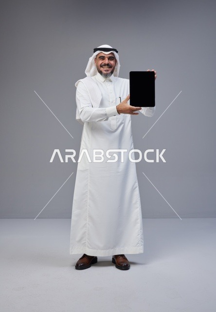 Saudi Man Holding Blank Tablet Screen in Studio