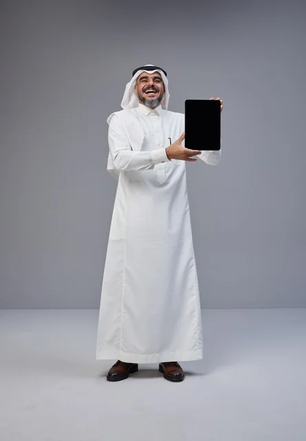 Saudi Man in Traditional Dress Holding Blank Tablet Screen