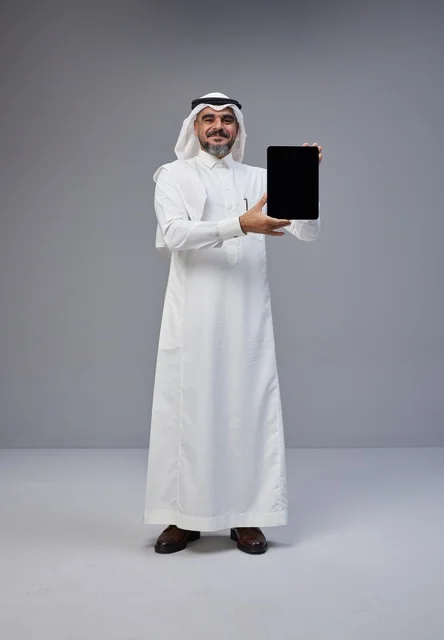 Saudi Man in Traditional Dress Holding Blank Tablet