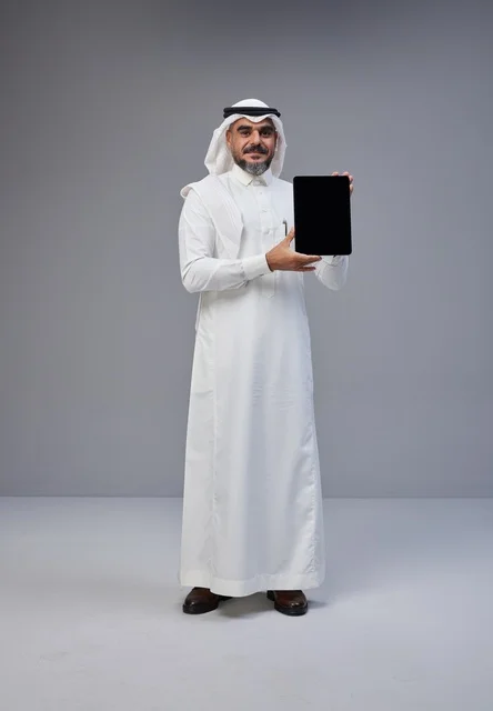 Saudi Man in Traditional Dress Holding Tablet Mockup