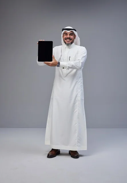 Saudi Man in Traditional Thobe Holding Tablet Mockup