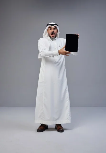 Surprised Saudi Man Holding Tablet Blank Screen