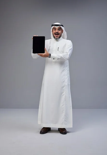 Saudi Man in Thobe Holding Tablet with Blank Screen