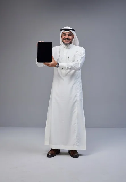 Saudi Man in Traditional Dress Holding Blank Tablet