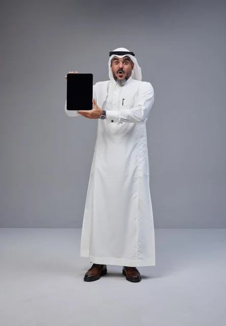 Saudi Man Holding Blank Tablet with Surprised Face