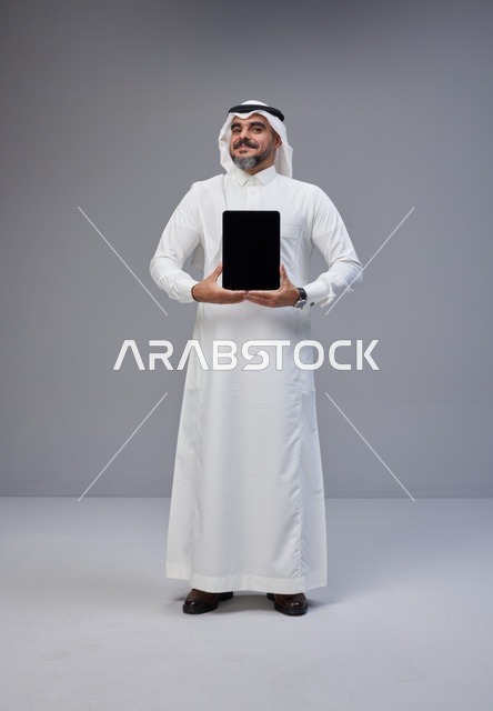 Saudi Man Holding Blank Screen Tablet in Studio